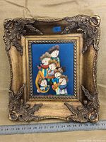 Full view of original oil painting on canvas by Joyce Roybal framed in ornate gold frame with ruler for scale.