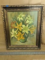 Frontal view of the original signed floral painting showing flowers in yellow, white, and orange in a green vase with background and frame details.