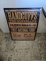 Framed vintage music poster with black and tan text about Handcuffs The Donnellys first national tour at Neptune Theatre, Nov 26, includes ticket prices and contact info.