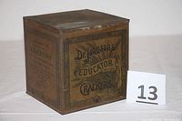 Front angled view of the vintage Dr. Johnson's Educator Crackers tin box showing the logo and design.