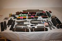 Full overview of all items including locomotives, track pieces, switches, power pack on white tablecloth