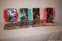 Nineteen individually packaged sky lanterns of different colors displayed on a table with a number 20 card.