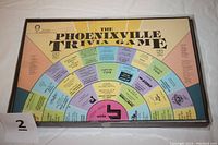Photo of the complete Phoenixville Trivia Game board showing the colorful circular path with question categories and logos.