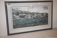 Full view of the framed print showing the entire artwork, matting, and frame with label number '124' on the top left corner of the glass frame.