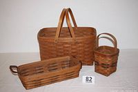 Full set of three Longaberger handwoven baskets in various sizes and condition, shown from front