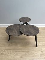 Front view of the 3-tier coffee table showing the size and shape of round tabletops and supporting angled legs.