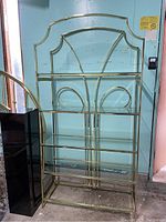 Full view of vintage 4-tier brass and glass shelf, showing overall structure and condition.