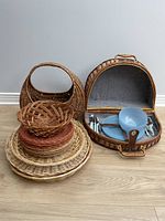 Full view of all wicker items including baskets and picnic basket with contents