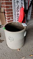 Full view of the antique vintage stoneware crock showing cylindrical shape and handles.