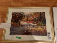 Full front view of framed watercolor artwork showing the autumn river scene with fly-fisherman and signature.