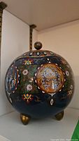 Photo of the cloisonne bowl showing circular enamel medallions and part of the lid knob.