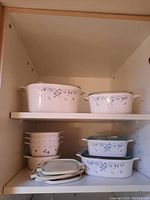 Shelf with small stackable CorningWare dishes and plastic lids