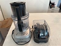 Front view of assembled food processor showing base, bowl, lid and controls