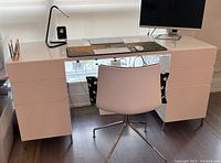 Front view showing drawer banks and open knee space with accessories