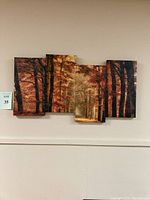Full view of all four canvas panels hung on wall showing composite fall forest scene.