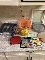 Photo showing the entire lot including silver tray, pumpkins, clock, coffee crate, garland, home stickers, hot pads, tea towel, and first aid kit.