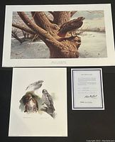 Both Michael Dumas signed and numbered prints with documentation certificate included, laid flat on dark background.