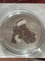 Close-up photo of the 2013 Canada $20 silver coin featuring Santa Claus, showing coin details and inscriptions.