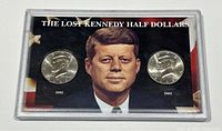 Front view of packaging containing 2002 and 2003 Kennedy Half Dollar coins with a portrait of John F. Kennedy and label 'The Lost Kennedy Half Dollars'.