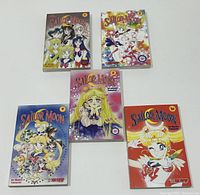Top view of five vintage Sailor Moon graphic novels arranged in a group showing front covers, volumes #6, #7, #8, #9, and #10.