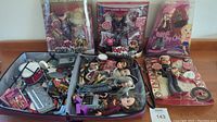 Three sealed Bratz dolls behind open case of loose dolls and accessories