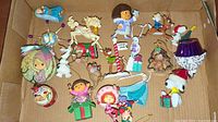 Overview photo of the Hallmark character Christmas ornaments in a box showing a variety of characters including Dora the Explorer, Elsa from Frozen, and Snoopy.