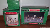 Two green boxed sets of Native American style nativity figurines, one labeled 'Native American Nativity' and the other 'Native American Ambitions'.
