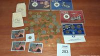 Full view of collection with loose coins, two nickel series coin sets, and a blue proof set case
