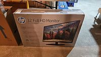 Box of HP 32 Full HD Monitor showing front image with monitor and stand, and product features.