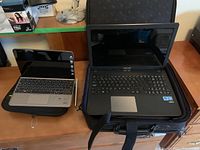 Both devices on desk, laptop on soft case, tablet on folio