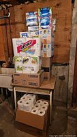 Wide shot showing stacked paper goods in basement