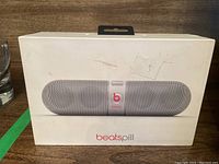 Front of original box showing Beats Pill speaker image and logo