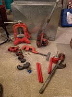 Overview of Ridgid pipe tools set including vise, cutter, threader, wrench, oil can, handle extensions and fittings
