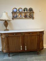 Front view of closed buffet showing marble top, drawers, doors and hardware.