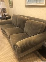 Left-front angled view showing overall sofa frame, arm design and loose cushions