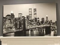 Frontal view of the large black and white canvas print showing the Brooklyn Bridge and Twin Towers at night.