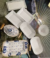All serving dishes arranged on table surface; visible variety and condition