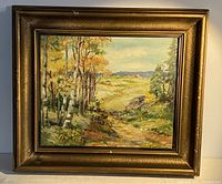 Full view of oil painting in wood frame showing autumn landscape with birch and pine trees, path, and distant hills.