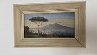 Full view of framed oil painting showing Napoli with Mount Vesuvius under natural light, showcasing the entire composition and frame.