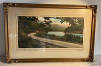 Full view of the framed hand tinted photograph featuring the lake and road scene.