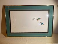 Framed embossed print with triple matting, showing the entire artwork with bear and birds composition