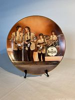 Front view of the plate showing The Beatles performing, gold rim visible.