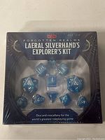 Front view of sealed Laeral Silverhand's Explorer's Kit with visible blue dice set.