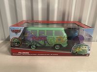 Front view of Fillmore die cast van in original box showing colorful graffiti design and oil bubbles accessory.