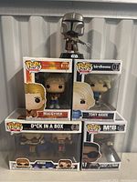 Front view of collection stacked showing MacGyver, Tony Hawk, Dick in a Box 2-pack, Men in Black Agent J & Frank, and Mandalorian on top.