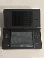 Top view of Nintendo DS XL opened, showing dual screens and control buttons.