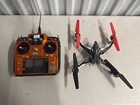 Top view of both the radio control transmitter and the drone showing overall condition and details.