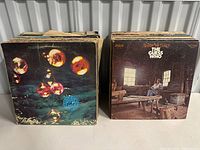 Two stacks of records showing Deep Purple self-titled album and Share the Land by The Guess Who.