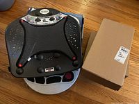 Photo showing multiple Dr Ho devices including the Perfect Back Rest, a circulation promoter, and a boxed item presumably another circulation promoter.