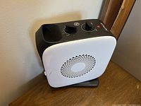 Front and top view of Noma ceramic heater showing control knobs and power indicator light